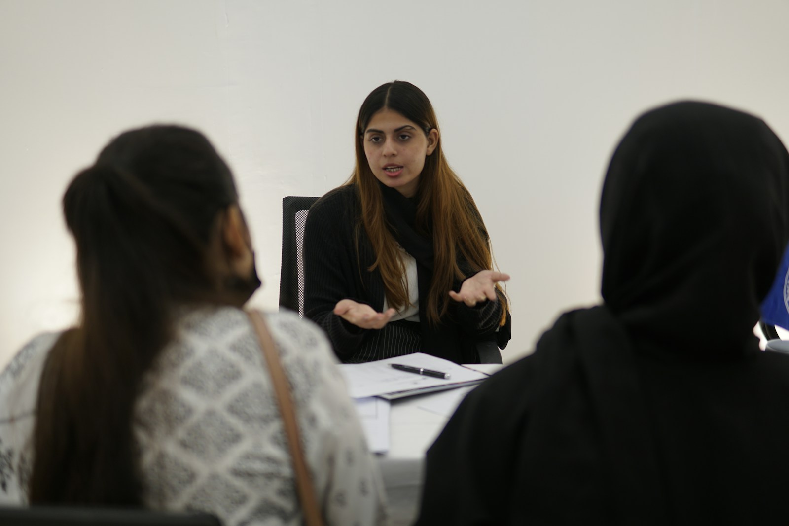 A senior woman leading a business discussion, representing fractional marketing leadership