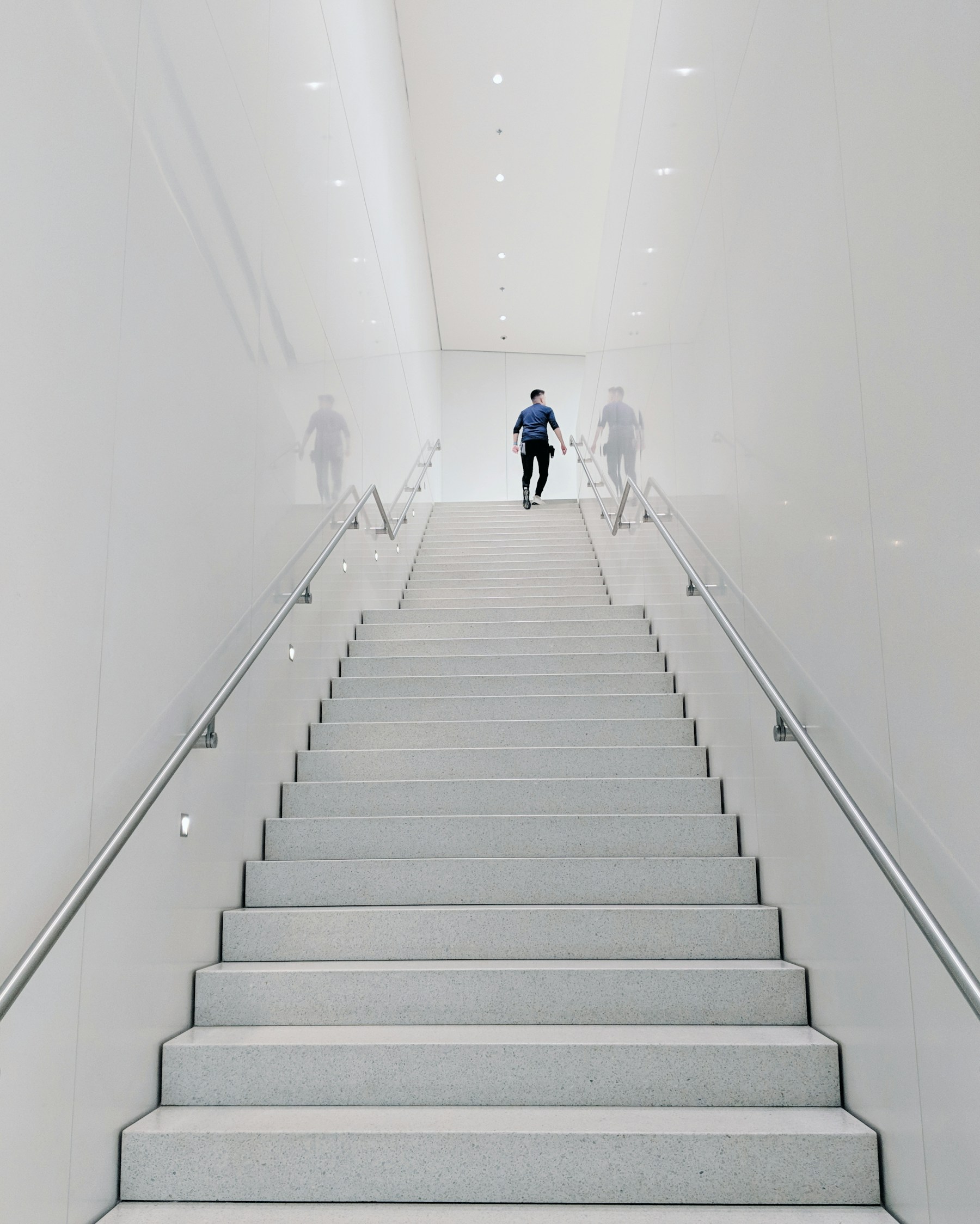 A professional moving up a staircase, representing momentum and purposeful progress